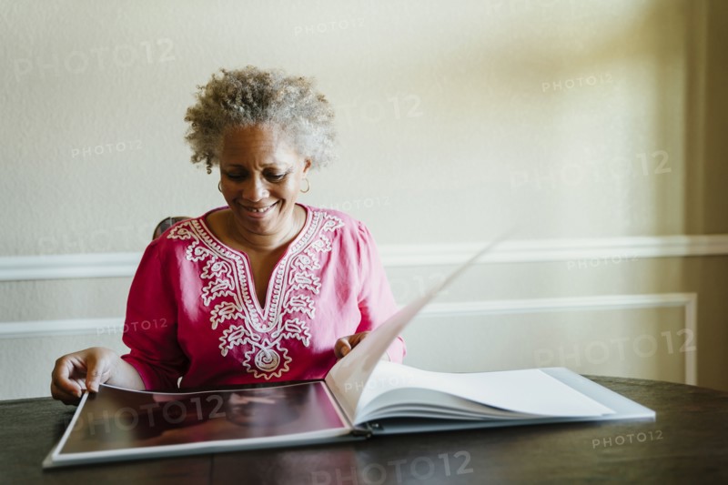 Black woman enjoying photo album
