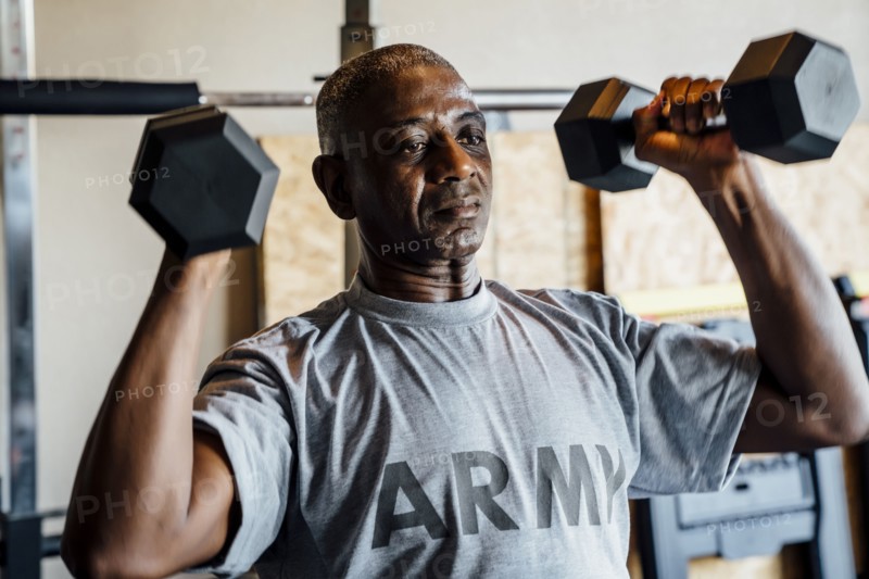 Black man lifting weights in garage