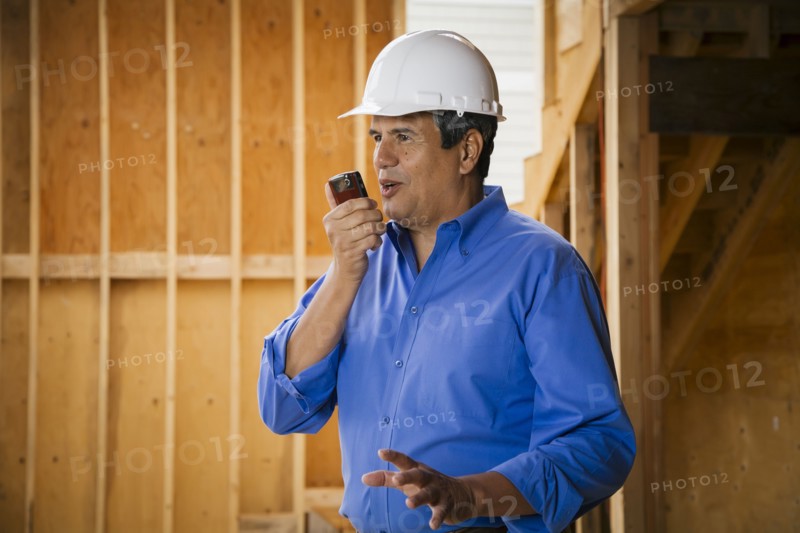 Native American construction worker talking on cell phone