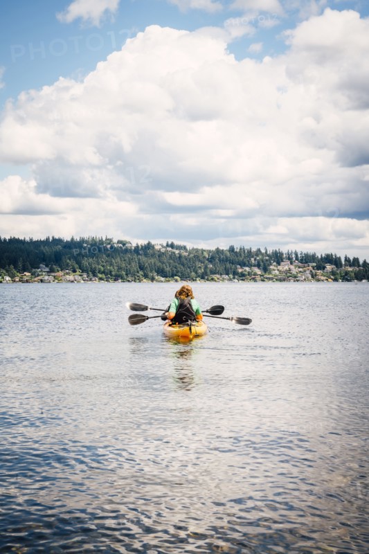 Man and woman in kayak holding paddles