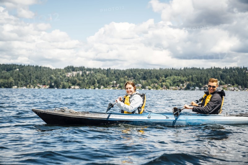 Caucasian man and woman paddling kayak