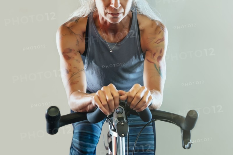 Caucasian woman riding stationary bicycle