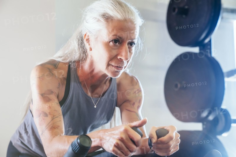 Caucasian woman riding stationary bicycle