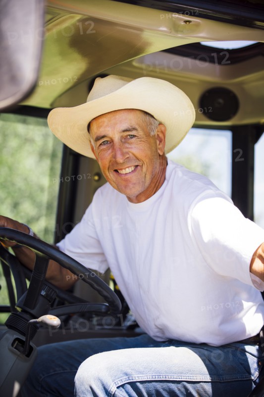 Portrait of smiling Caucasian farmer in tractor