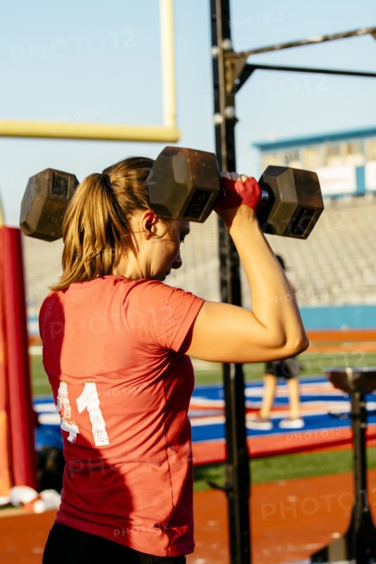 Caucasian woman lifting weights outdoors