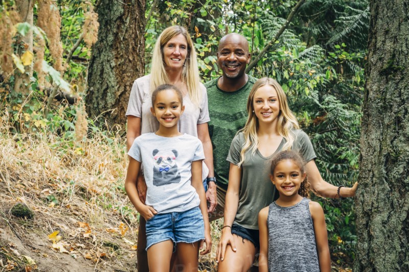 Multi-ethnic family posing in forest