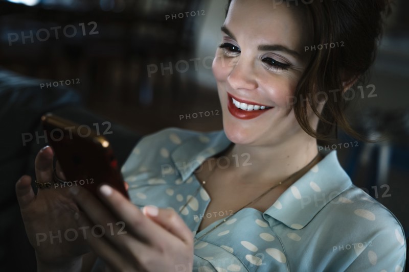 Woman texting on cell phone in the dark