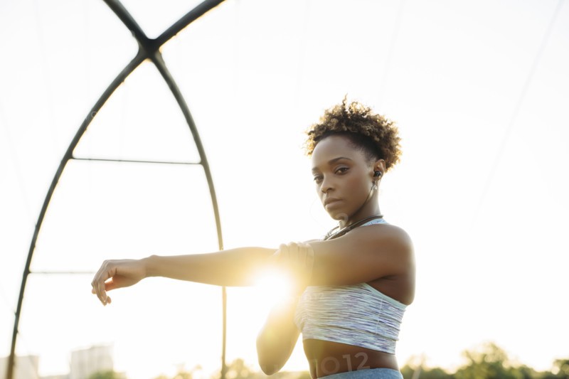 Portrait of mixed race woman stretching arms
