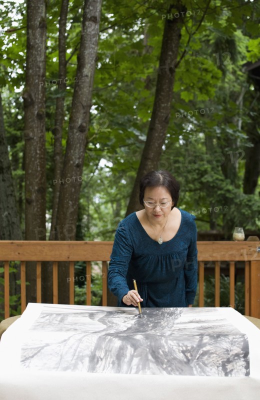 Chinese woman painting outdoors