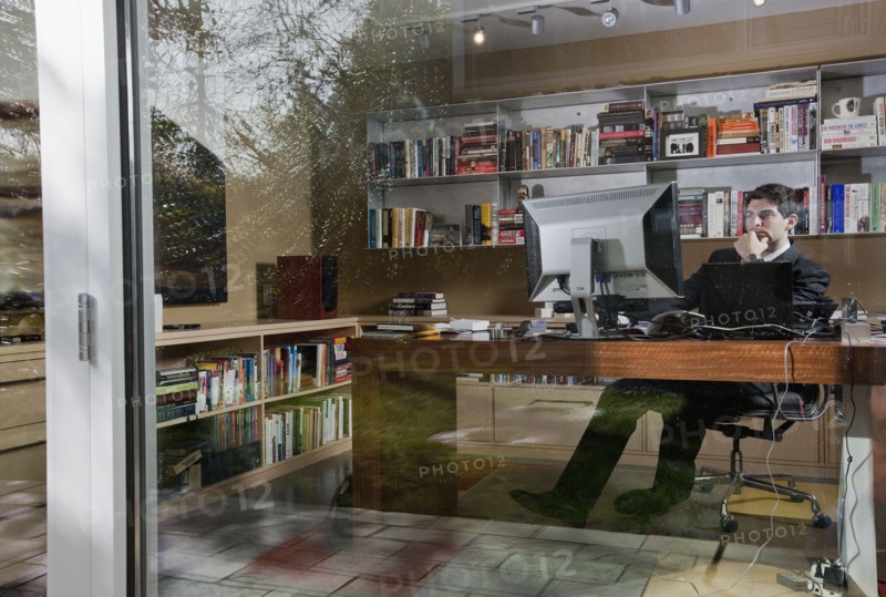 Mixed race businessman sitting at desk