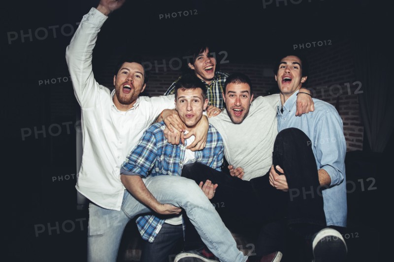 Laughing men playing at party at night