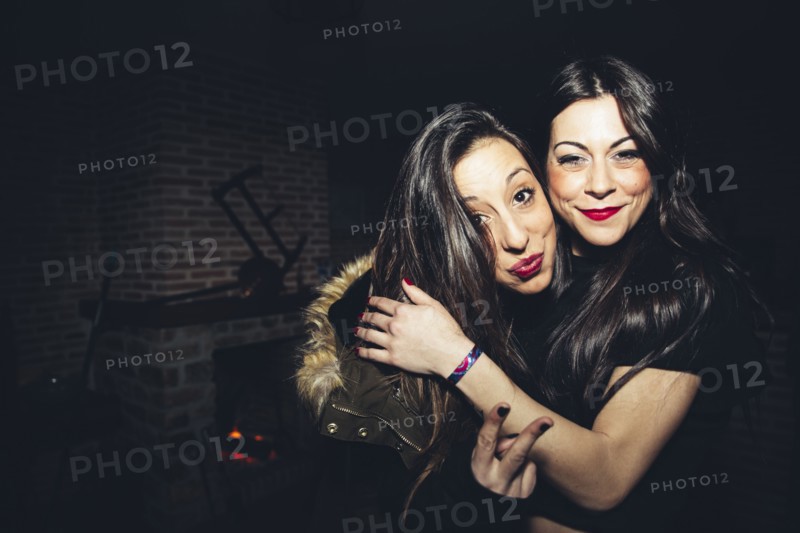 Smiling women hugging at party