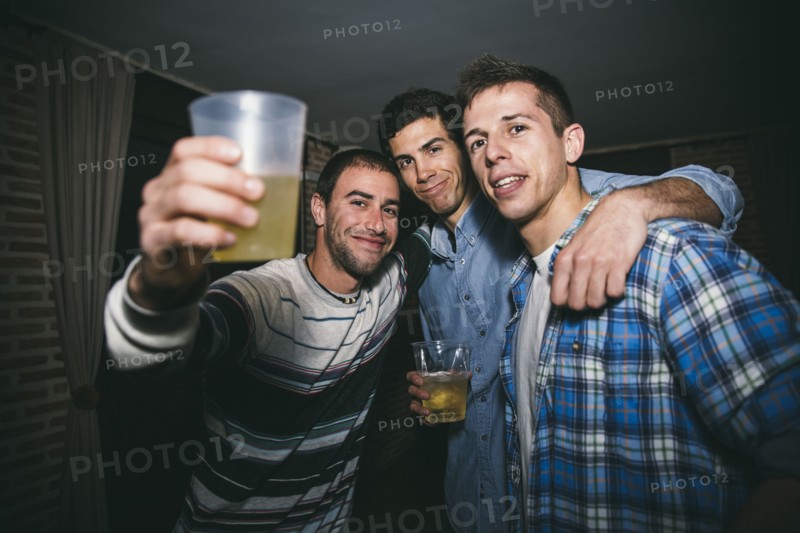 Smiling men drinking in nightclub