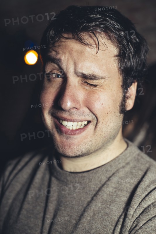 Close up of Hispanic man winking