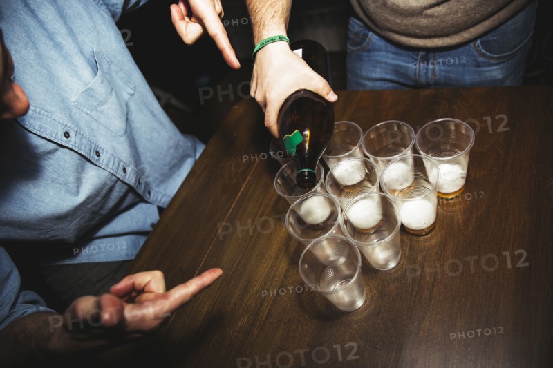 Man pouring drinks at party
