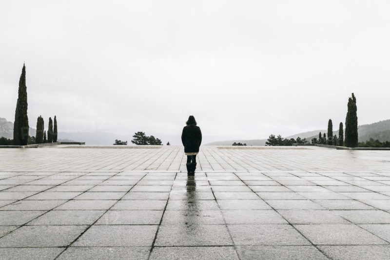 Caucasian woman walking in concrete courtyard