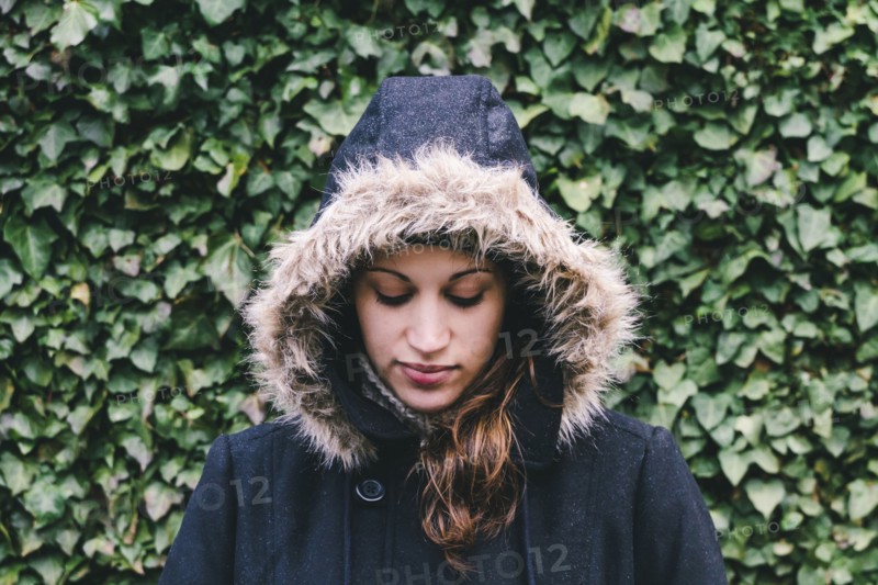 Caucasian woman wearing fur hood