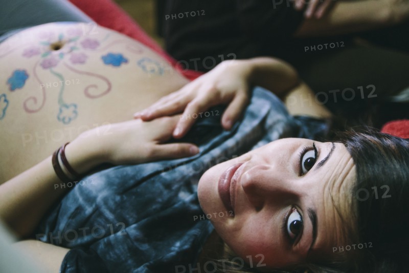 Pregnant Caucasian woman with drawings on belly