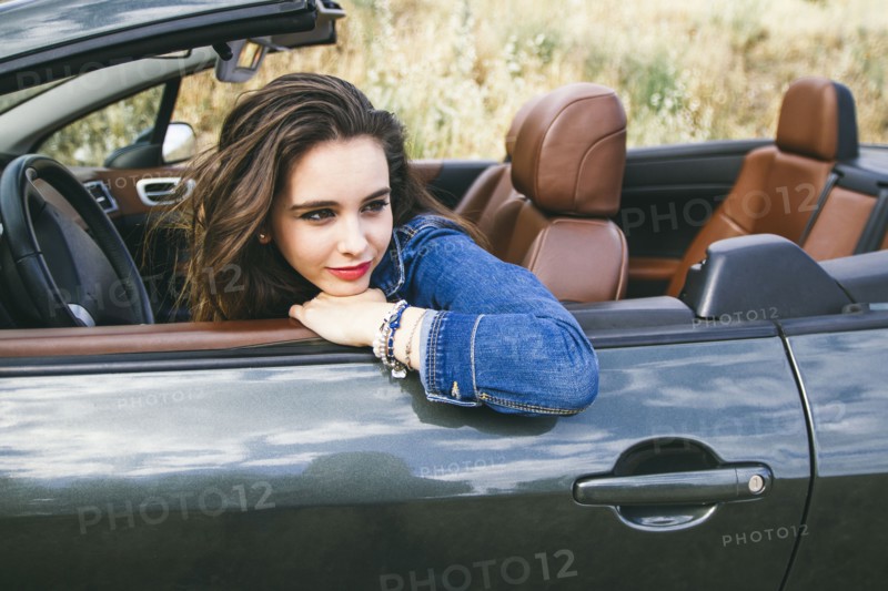Caucasian woman sitting in convertible