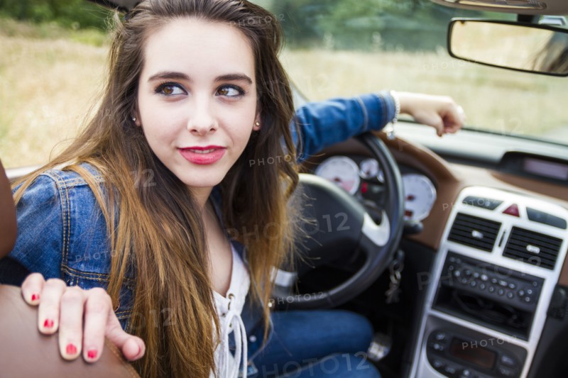 Caucasian woman sitting in convertible