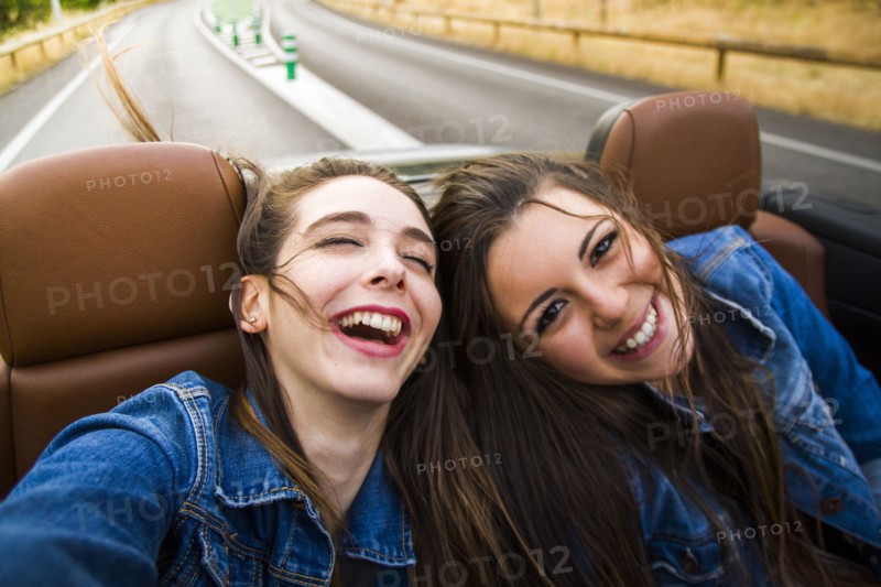 Women laughing in convertible