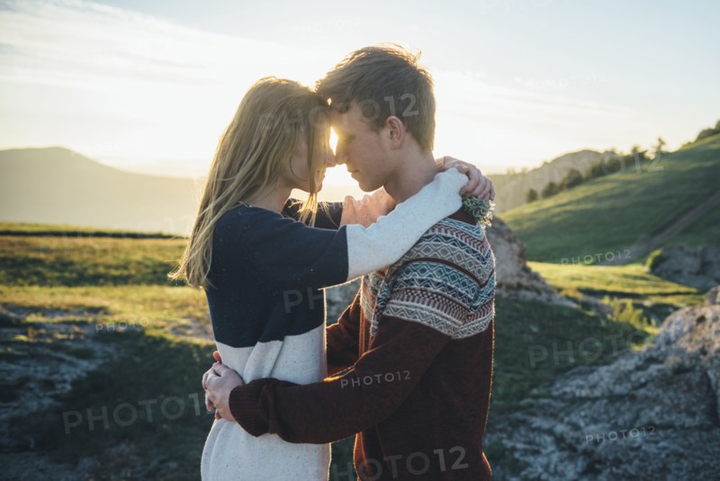 Caucasian couple rubbing noses and hugging