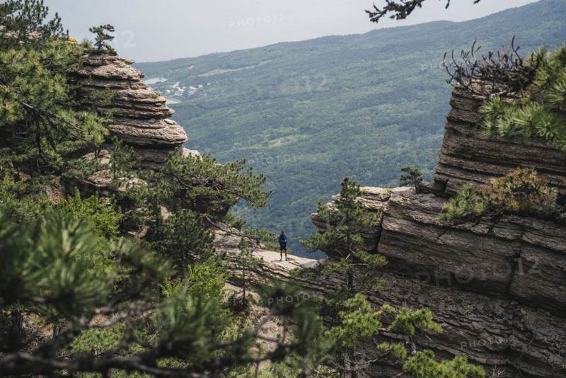 Distant Caucasian man standing in mountain landscape