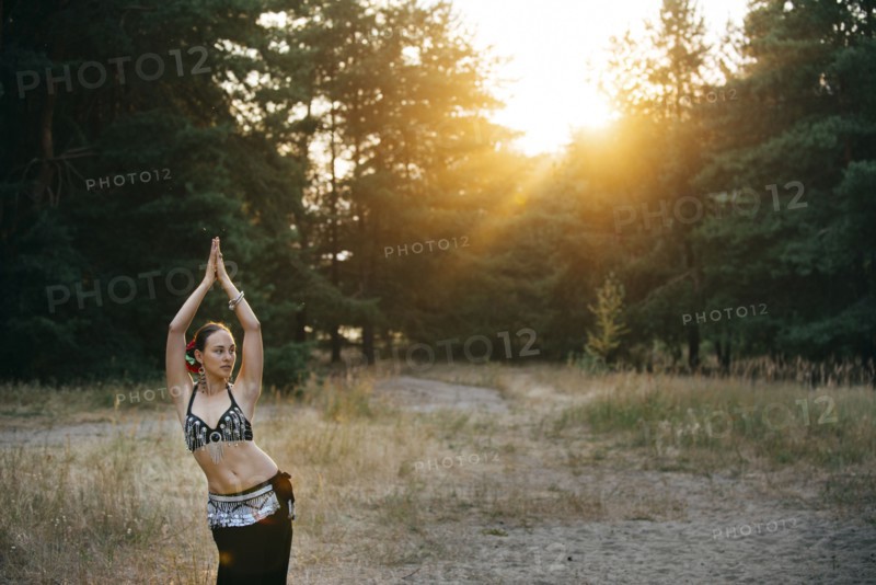 Caucasian belly dancer in field