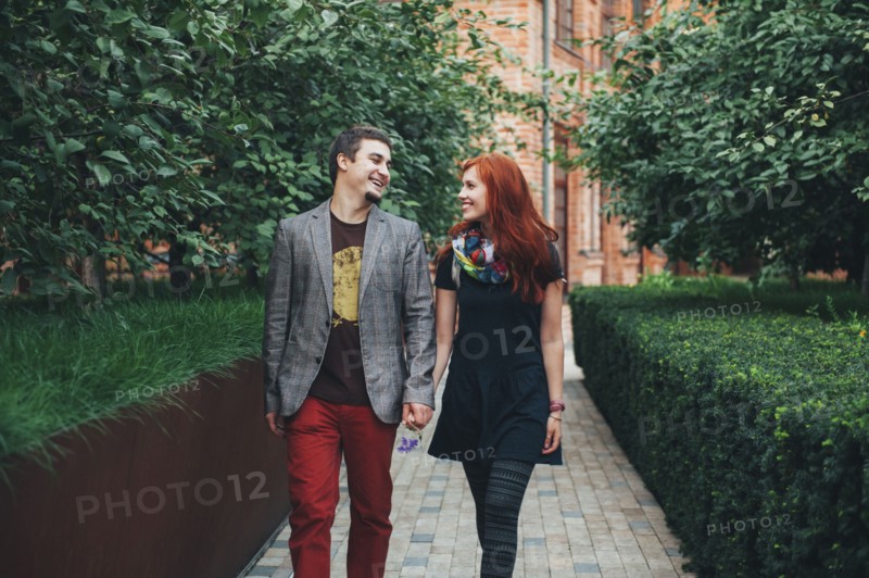 Smiling Caucasian couple walking in city