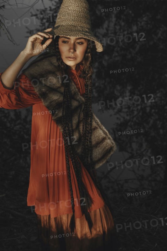 Caucasian woman wearing traditional clothing at night
