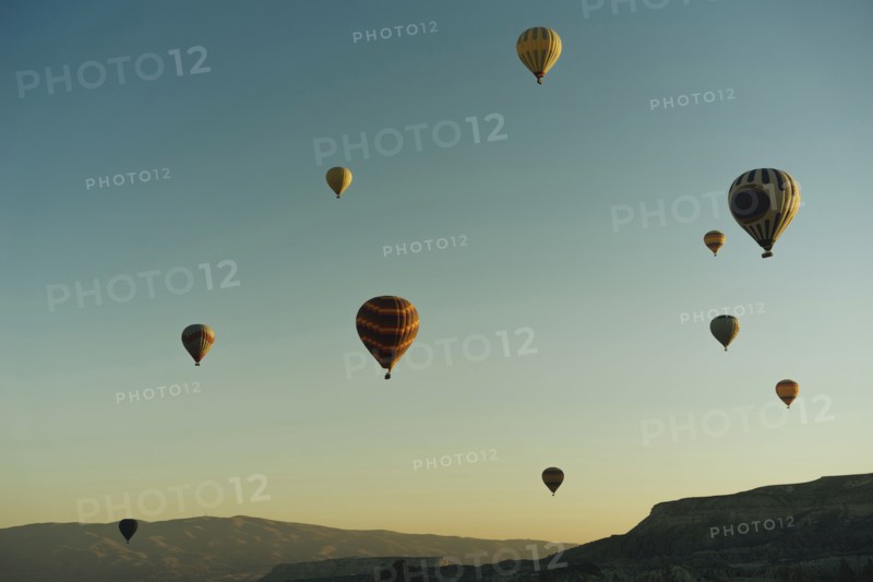 Hot air balloons flying at sunset