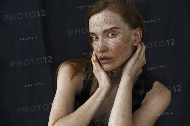 Close up of serious Caucasian woman with freckles