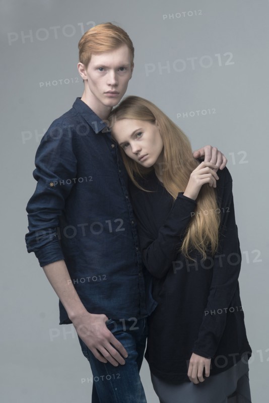 Portrait of serious Caucasian couple hugging