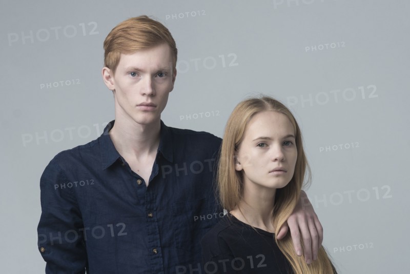 Portrait of serious Caucasian couple hugging