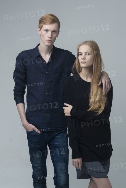 Portrait of serious Caucasian couple hugging