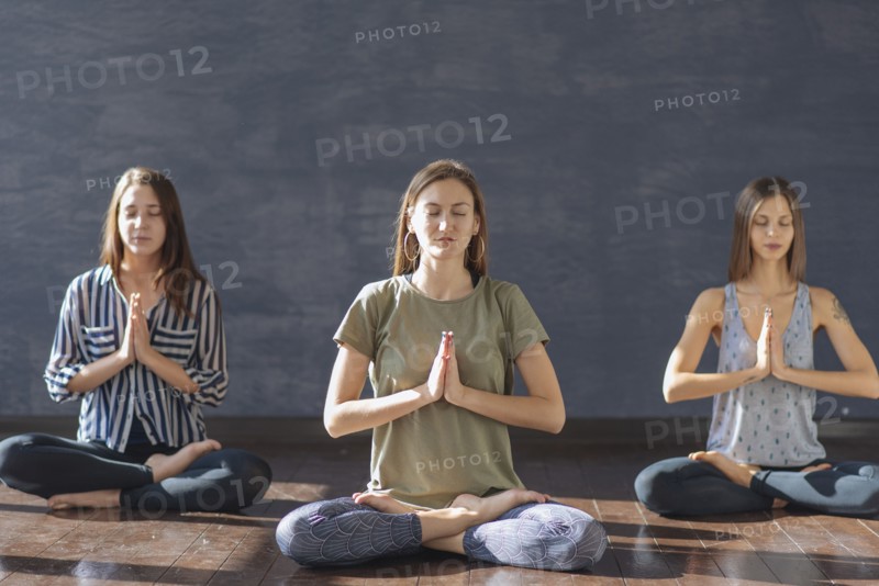 Caucasian women meditating in yoga class