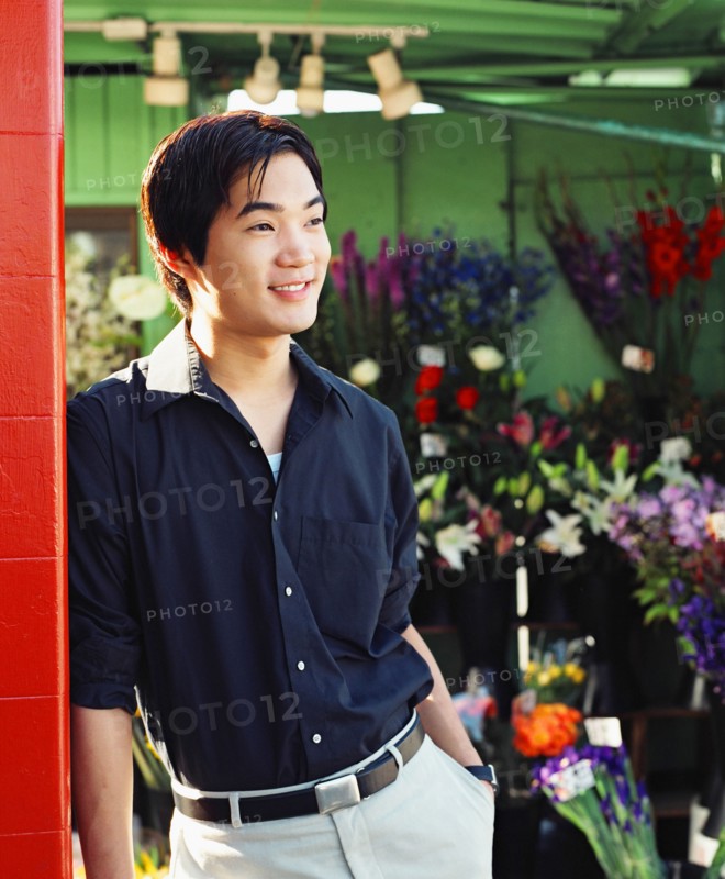Young man in flower shop