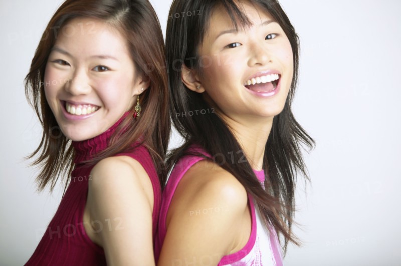Portrait of sisters back to back