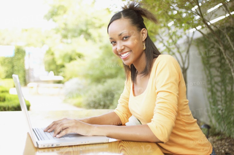 Portrait of teenage girl typing on laptop