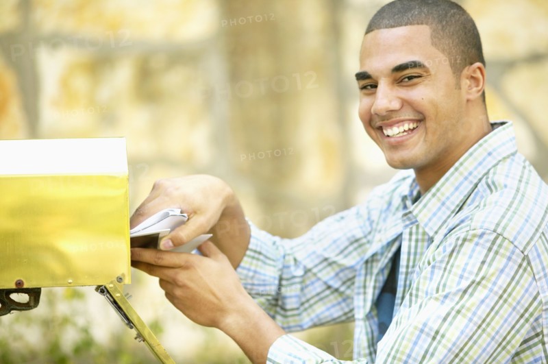 Man getting mail from mailbox