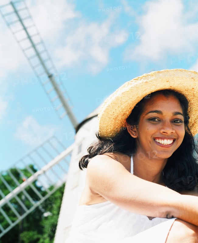 Young woman smiling with sun hat