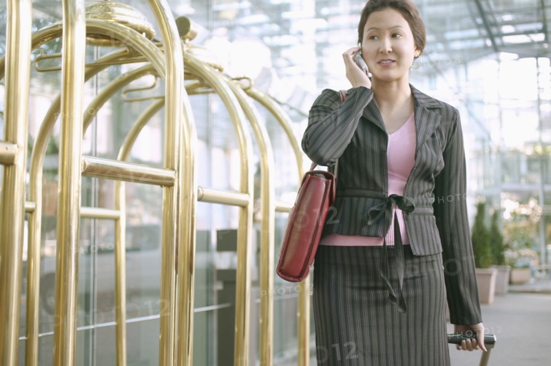 Businesswoman on mobile phone in hotel lobby