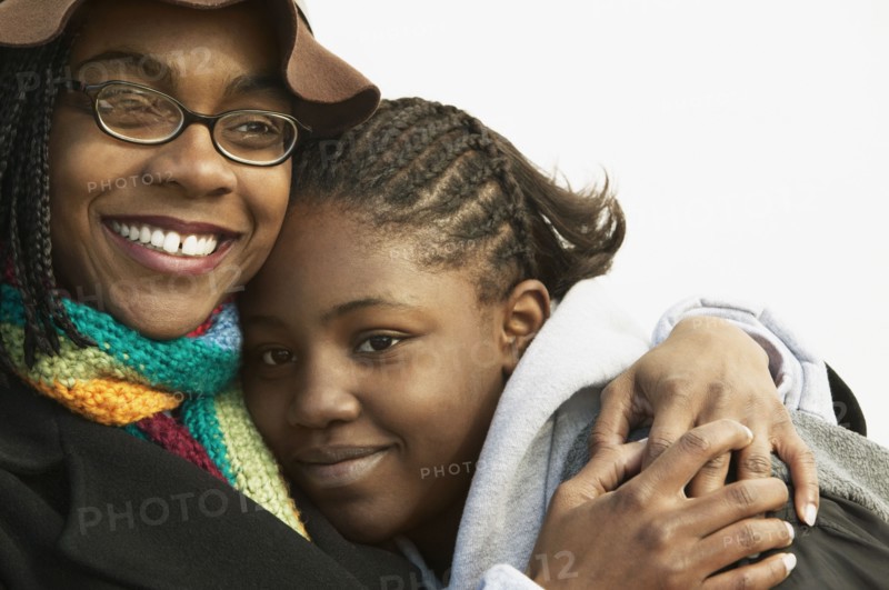Mother hugging daughter