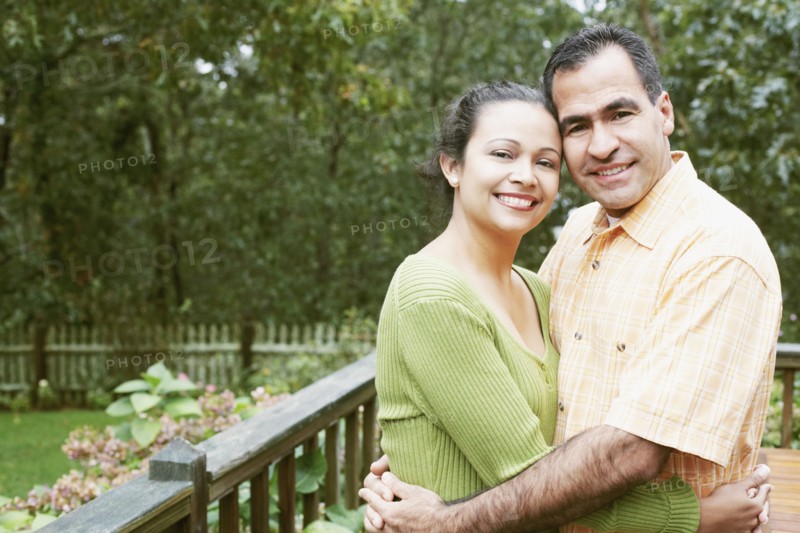 Couple hugging in their backyard