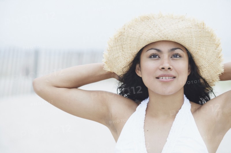 Young woman wearing a straw hat