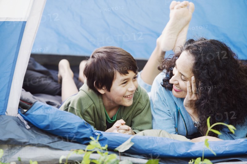 Mother and son laying in tent talking