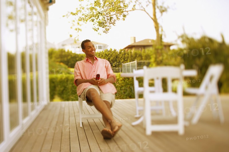 Hispanic man sitting on patio