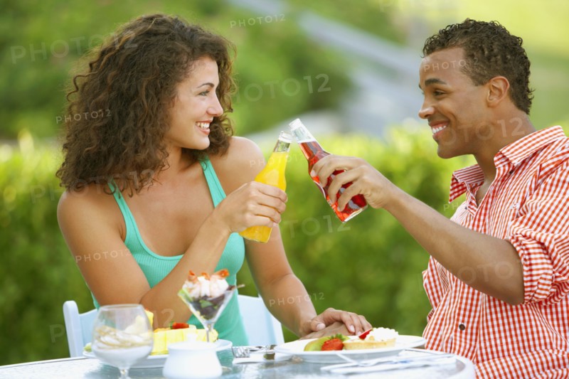Couple toasting at outdoor restaurant