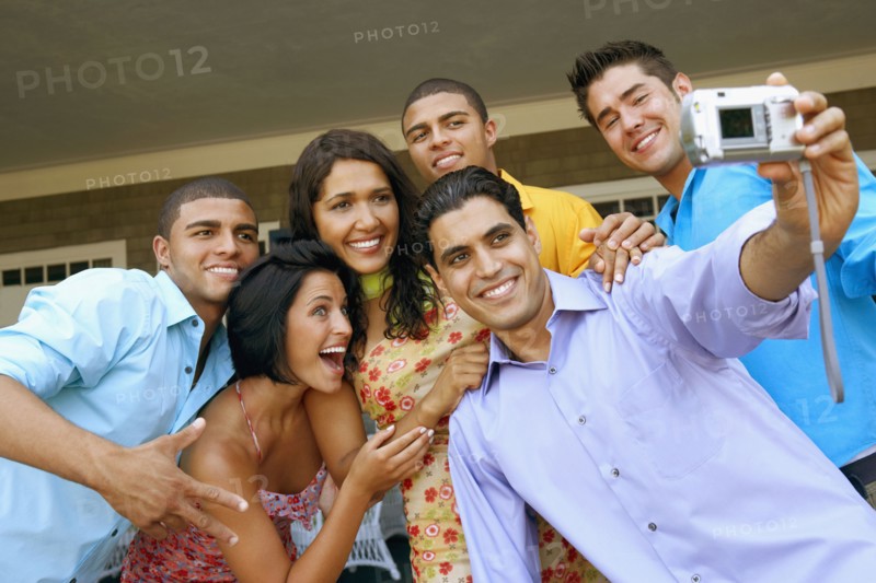 Multi-ethnic friends taking own photograph