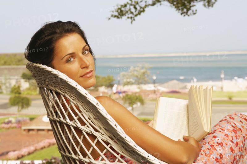 Young woman reading outdoors
